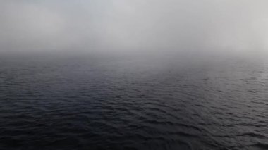 Sakin suda sisli bir gün, görüş mesafesi çok düşük. Sakin ve atmosferik deniz manzarası. Hava, ruh hali, doğa ve manzara görselleri için harika..