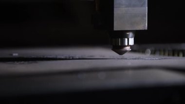 Bir CNC lazer kesme makinesi tam olarak metal bir levhayı keser ve parlak kıvılcımlar üretir. Bu endüstriyel süreç modern teknolojiyi ve yüksek teknoloji metalciliği sergiliyor.