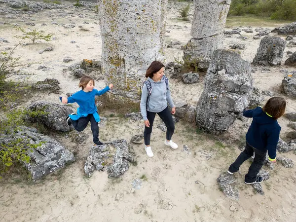 Anne ve iki çocuk kurak, yarı çöl bir arazide kayalık araziyi keşfediyorlar. Çocuklar taş formasyonlarıyla oynarken anne izliyor ve birlikte açık hava macerasının tadını çıkarıyor..