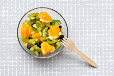 Bowl of fresh fruit salad. Mix of fruit in glass bowl top view