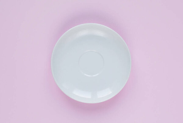 White plate, flat lay. Empty plate on pink background