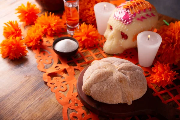 stock image Pan de Muerto, Sugar skull and Cempasuchil flowers or Marigold and Papel Picado. Decoration traditionally used in altars for the celebration of the day of the dead in Mexico