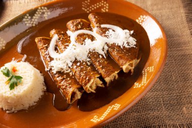 Chicken enmoladas. Also known as mole poblano enchiladas, they are a typical Mexican dish that is very popular in Mexico and the rest of the world.