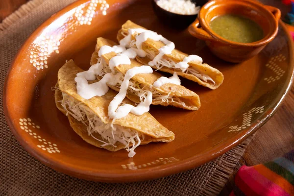 Potato quesadillas. Fried quesadillas made with corn tortillas, they can be filled with any dish or ingredient, such as meat, potato or fish such as marlin or tuna, popular during the Lenten season.