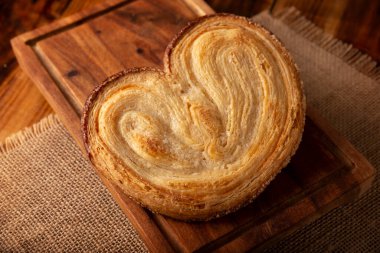 Oreja. Mexican sweet bread made with puff pastry, its name comes from its shape similar to that of ears, of French origin, where it is known as Elephant Ear or Palmier Puff Pastry. clipart