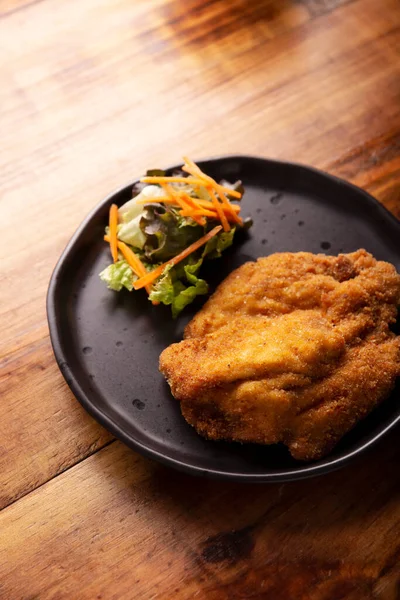 stock image Chicken Milanese. Delicious crispy, quick and easy recipe, made with thin skinless and boneless chicken breasts or cutlets, lightly breaded and deep fried.