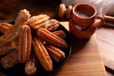 Churros. Fried wheat flour dough, a very popular sweet snack in Spain, Mexico and other countries where it is customary to eat them for breakfast or snack accompanied by hot chocolate or coffee. clipart