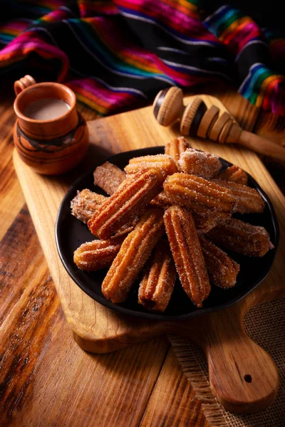 stock image Churros. Fried wheat flour dough, a very popular sweet snack in Spain, Mexico and other countries where it is customary to eat them for breakfast or snack accompanied by hot chocolate or coffee.