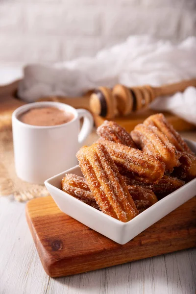 Stock image Churros. Fried wheat flour dough, a very popular sweet snack in Spain, Mexico and other countries where it is customary to eat them for breakfast or snack accompanied by hot chocolate or coffee.