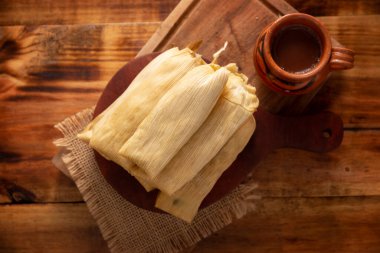 Tamales. Prehispanic dish typical of Mexico and some Latin American countries. Corn dough wrapped in corn leaves. The tamales are steamed. clipart