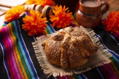 Pan de Muerto. Ölü sezonunda tüketilen susam tohumlu tipik Meksika tatlı ekmeği. Sunaklarda ve sunaklarda temel bir unsurdur.