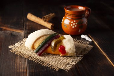 Traditional Kings day cake also called Rosca de Reyes, roscon, Epiphany Cake and with a clay Jarrito. Mexican tradition on January 5th