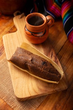 Çikolatalı Tamale. Meksika ve bazı Latin Amerika ülkelerinin tipik İspanyol yemekleri. Mısır yaprağına sarılmış mısır hamuru. Tamaleler buğulandı. Yanında genellikle atole, sıcak çikolata ya da kahve olur.