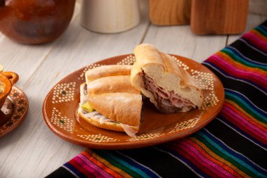 Mexican ham sandwich, in Mexico it is called Torta de Jamon, it is the most popular of the Mexican Tortas and the recipe varies depending on who prepares it, made with bolillo or telera bread. clipart