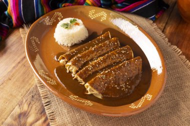 Chicken enmoladas. Also known as mole poblano enchiladas, they are a typical Mexican dish that is very popular in Mexico and the rest of the world.