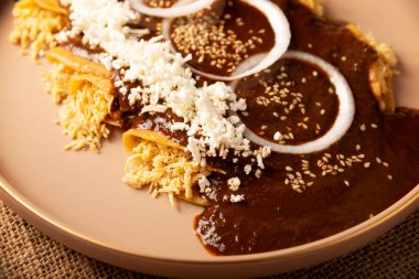 Chicken Enmoladas. In Mexico they are called Enchiladas de Mole Poblano, corn tortillas folded and filled with shredded chicken bathed in a sauce of chilies and many more ingredients called mole. clipart