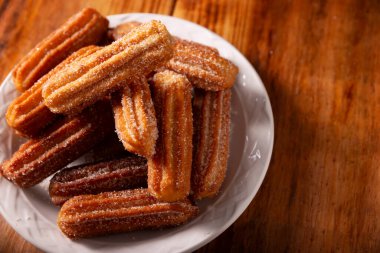 Kurabiye. Kızarmış buğday unu hamuru, İspanya, Meksika ve diğer ülkelerde sıcak çikolata ya da kahvenin eşlik ettiği kahvaltıda ya da atıştırmaya alışıktır..