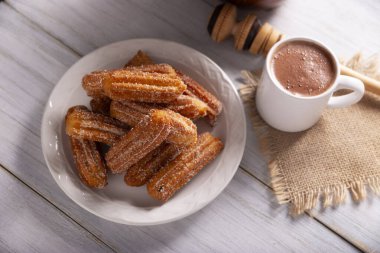 Kurabiye. Kızarmış buğday unu hamuru, İspanya, Meksika ve diğer ülkelerde sıcak çikolata ya da kahvenin eşlik ettiği kahvaltıda ya da atıştırmaya alışıktır..