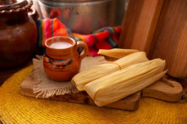 Tamales. Traditional dish typical of Mexico and some Latin American countries. Corn dough wrapped in corn leaves. The tamales are steamed. clipart