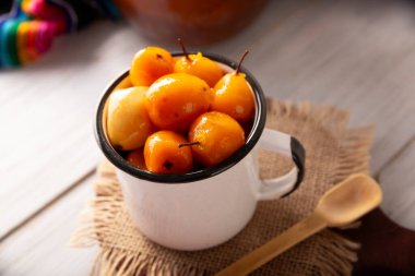 Tejocote en almibar. Typical Mexican dessert made with Tejocote (Crataegus mexicana), a Mexican fruit in syrup, a fruit widely used in autumn, the Day of the Dead, posadas and the Christmas season.