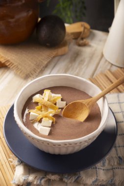 Creamy bean soup. In Mexico known as Crema de Frijoles, nutritious homemade food recipe, commonly accompanied with cheese, cream, avocado and corn tortilla cut into strips and fried.