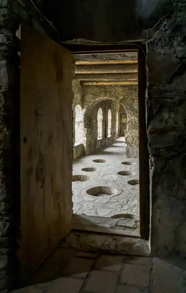 stock image Ancient winnery of Nekresi monastery, Georgia. Qvevri holes in the floor. Arched stone walls and windows.