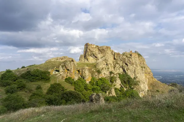 stock image The ruins of a medieval fortress on top of a huge rock. Stone walls are a continuation and are