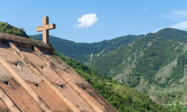 Roof and cross of Saint Giorgi church of Okhera village. Sapara monastery on the hill clipart