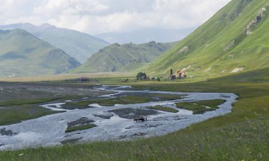 Many channels of the Terek River in the valley and view of Abano nunnery. Zakagori fortress on the hill clipart