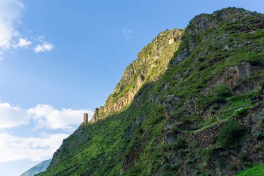 Signal tower on the edge of a cliff near the medieval village of Mutso. Blue sky with clouds clipart