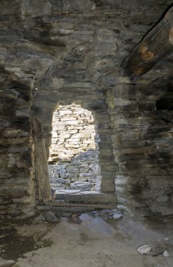 One of the rooms in the medieval village of Shatili. Stone walls and low doorway clipart