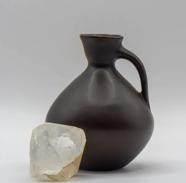 stock image Close up shot of modern clay jug for water or wine  and quartz crystal