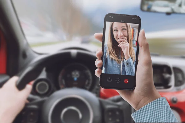 Distracted driver using a smartphone while driving the car