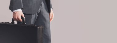 Corporate businessman holding a briefcase close up, business and finance concept, copy space