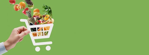 Tangan Memegang Ikon Troli Penuh Bahan Makanan Segar Online Belanja — Stok Foto