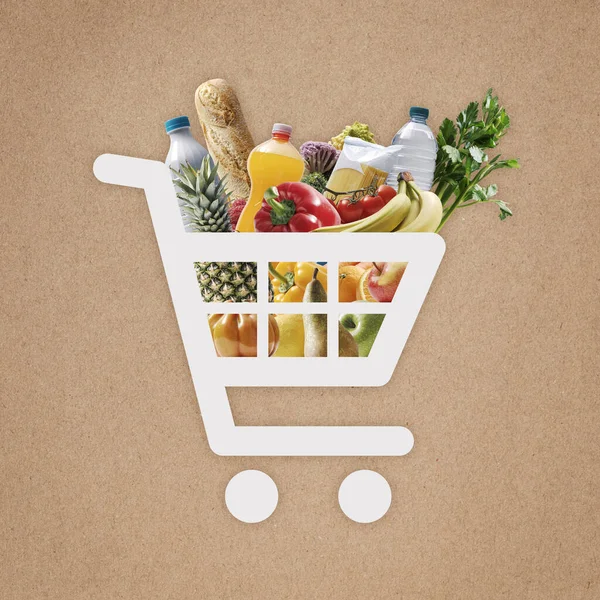 Online shopping app: shopping cart icon full of fresh groceries, brown paper in the background
