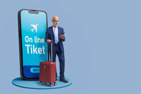 Businessman booking flight tickets online on his smartphone, travel and apps concept