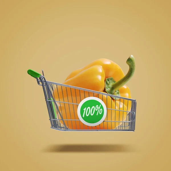 Flying shopping cart with fresh bell pepper, organic vegetables and grocery shopping concept