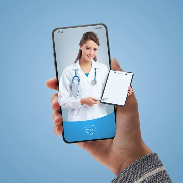 Smiling female doctor on smartphone screen giving a medical prescription: online doctor video consultation concept