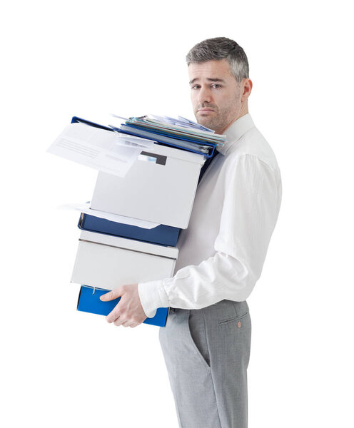 Frustrated sad businessman carrying a load of boxes and paperwork in the office, relocation, stress and responsibility concept