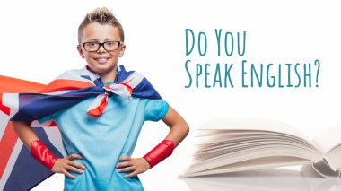 Happy superhero student learning English at school and open book