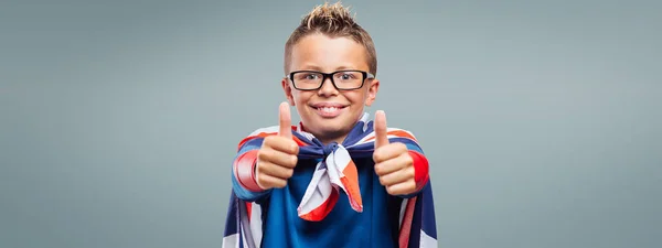 Smiling Cute Superhero Thumbs Wearing British Flag Cape — Fotografia de Stock