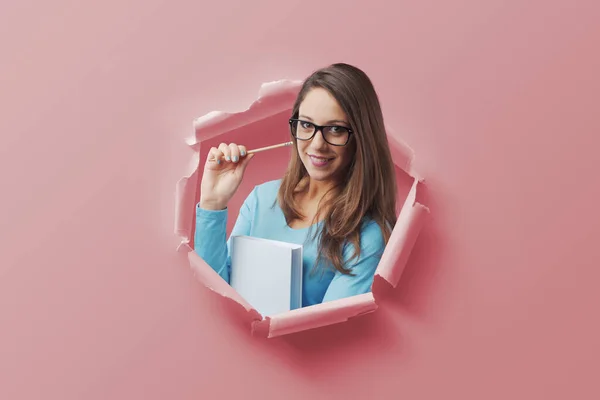 Happy Young Female Student Coming Out Torn Paper Hole Holding — Stock Photo, Image