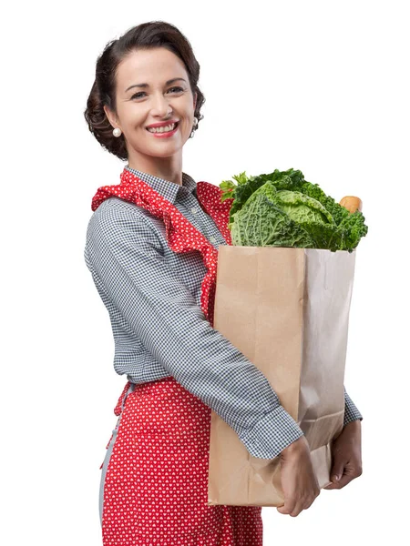 Uśmiechnięta Rocznika Kobieta Fartuch Trzymając Zakupy Worek Spożywczy — Zdjęcie stockowe