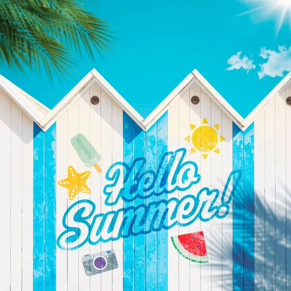 Hello Summer graffiti on wooden beach huts, summer vacations concept
