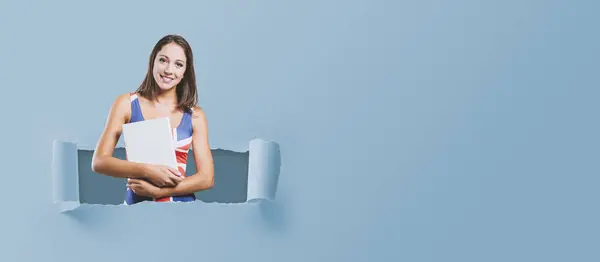 Smiling Young Girl Wearing British Flag Tank Top Holding Hardcover — Stock Photo, Image