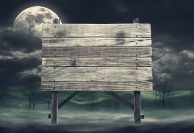 Old rough wooden sign surrounded by fog at night: mystery and horror concept, copy space clipart