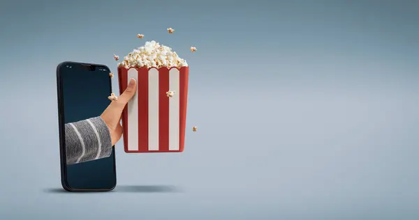 Hand Holding Popcorn Coming Out Smartphone Screen Entertainment Concept — Stock Photo, Image