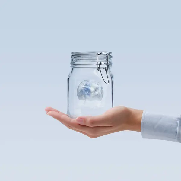 Female Hand Holding Sealed Glass Jar Containing Planet Earth Environmental — Stock Photo, Image