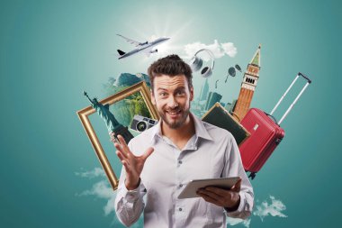 Happy man dreaming of traveling, he is surrounded by travel items and booking his trip online using a digital tablet clipart